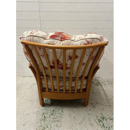 194 - A pair of light Ercol arm chairs upholstered in a floral linen