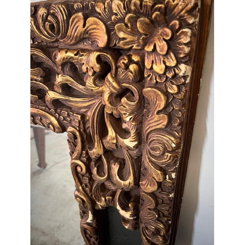 202 - A large scrolling embossed mirror. H149 X 124 X D65cm