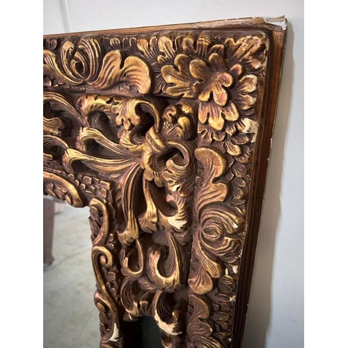 202 - A large scrolling embossed mirror. H149 X 124 X D65cm