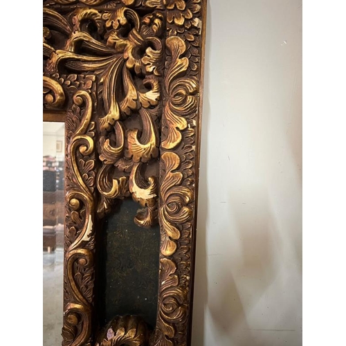 202 - A large scrolling embossed mirror. H149 X 124 X D65cm