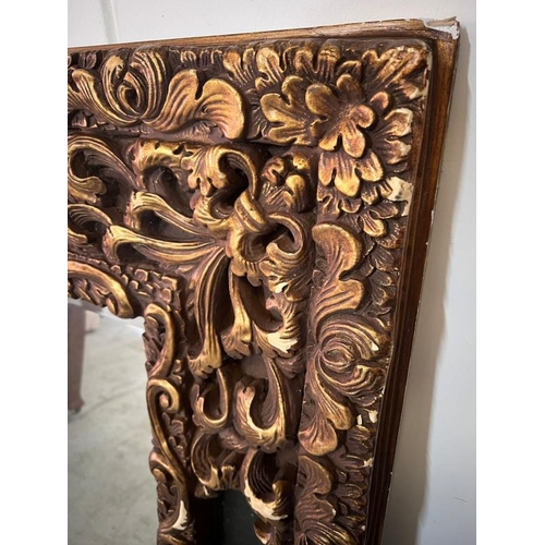 202 - A large scrolling embossed mirror. H149 X 124 X D65cm