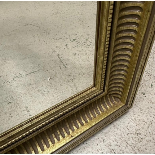203 - A gold painted bevel edged mirror 67cm x 96cm