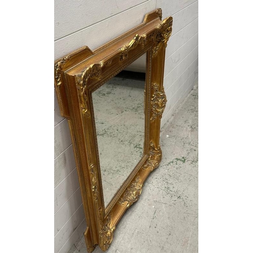 204 - A wooden gold painted mirror in the baroque style 79cm x 94cm