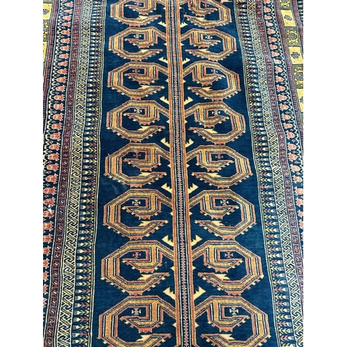 213 - A blue ground rug with geometric border 147x100 cm