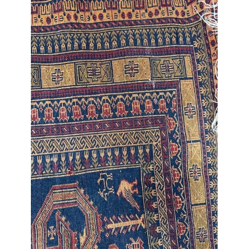 213 - A blue ground rug with geometric border 147x100 cm