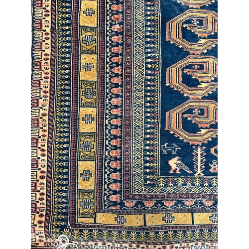 213 - A blue ground rug with geometric border 147x100 cm
