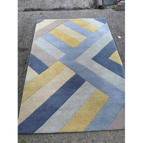 218 - A contemporary rug in a blue, yellow and green zigzag pattern. 162x234 cm