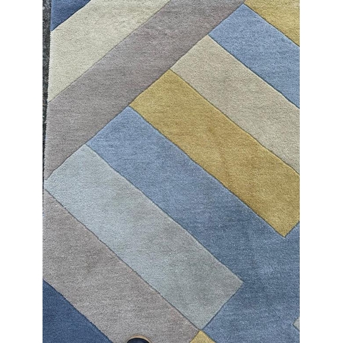218 - A contemporary rug in a blue, yellow and green zigzag pattern. 162x234 cm