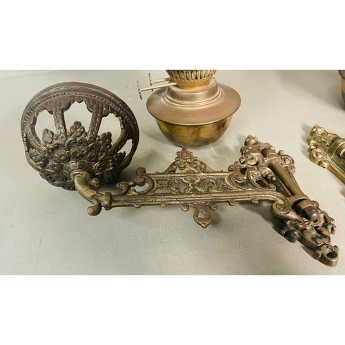 235 - A Pair of bras and glass wall oil lamps on ornate arm.
