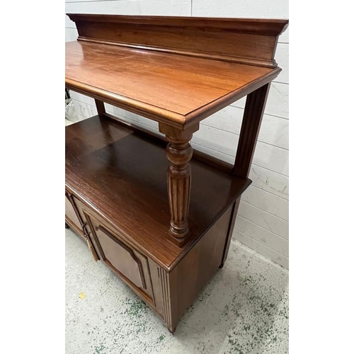 55 - A buffet sideboard with reeded arms and panelled doors on castors (H120cm W108cm D50cm)