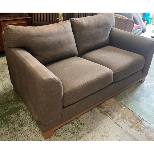 56 - A two seater brown sofa (H74cm W167cm D100cm)
