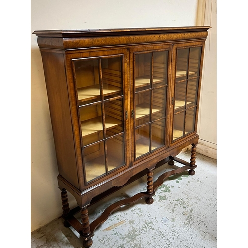 31 - Queen Anne revival style three door bookcase, rectangular top veneered with block moulding and a cus... 