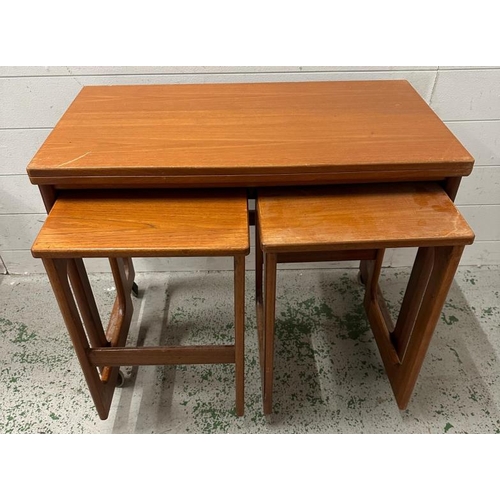 107 - A rest of three Mid Century tables by Macintosh on castors, the top table having a hinged swivel top