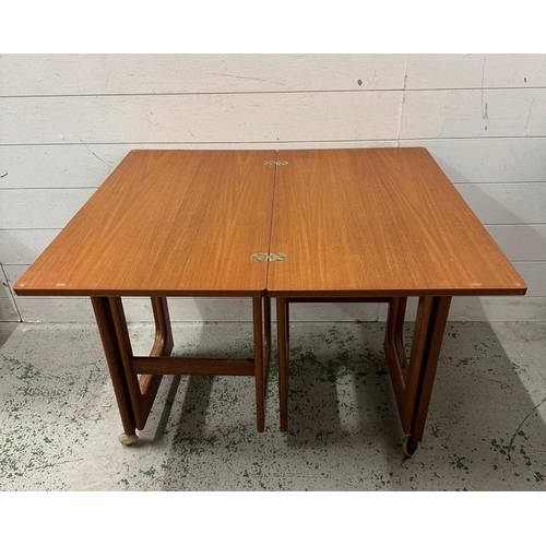 107 - A rest of three Mid Century tables by Macintosh on castors, the top table having a hinged swivel top