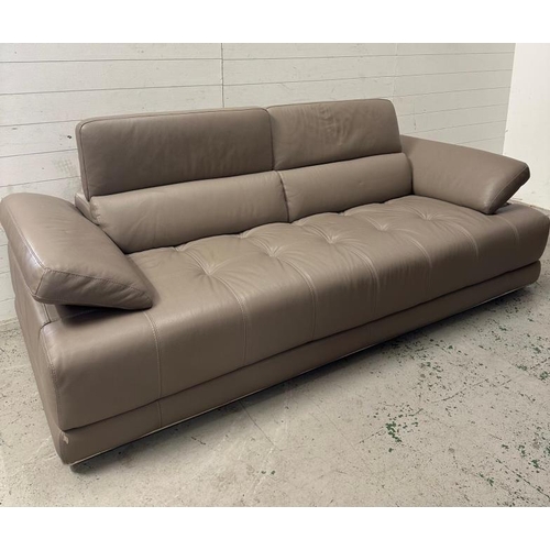 113 - A grey leather three seater sofa by Natuzzi with adjustable head and arm rests.