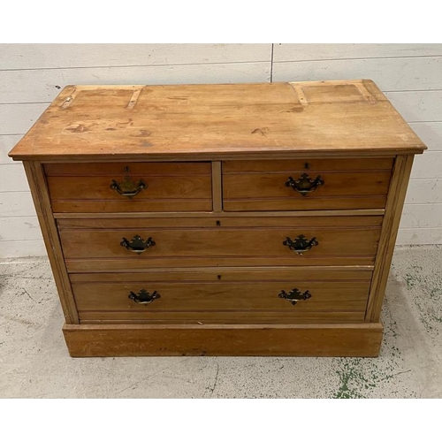 117 - Two over two pine chest of drawers with brass drop down handles (H81cm W106cm D47cm)