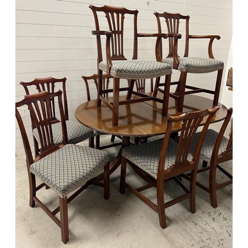 121 - A mahogany twin pedestal dining table with two carvers and six chairs (H73cm W165cm D106cm)