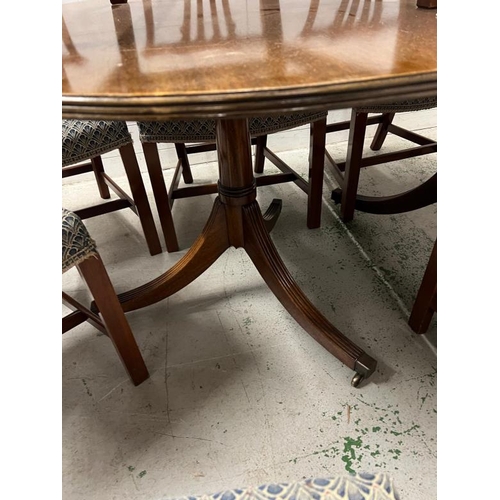 121 - A mahogany twin pedestal dining table with two carvers and six chairs (H73cm W165cm D106cm)