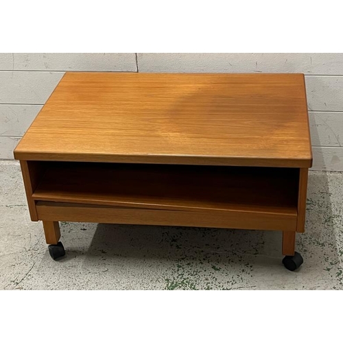 19 - A low teak side table on castors (H38cm W75cm D50cm)