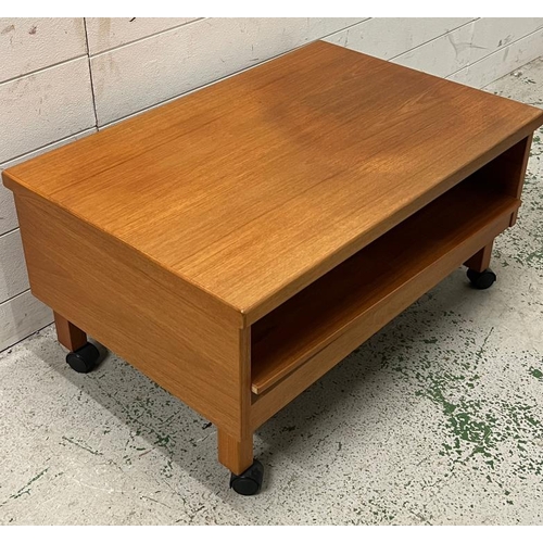 19 - A low teak side table on castors (H38cm W75cm D50cm)