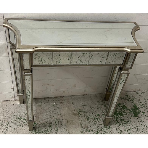 34 - A mirrored glass console table (H79cm W90cm D35cm)