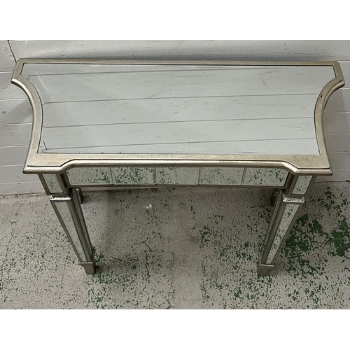 34 - A mirrored glass console table (H79cm W90cm D35cm)