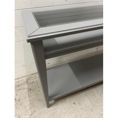 37 - An Ikea console table with glass top (H75cm W132cm D37cm)