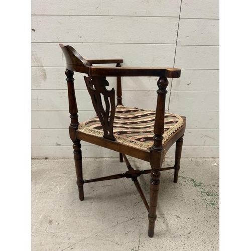 45 - An Edwardian inlaid corner chair upholstered in a floral pattern