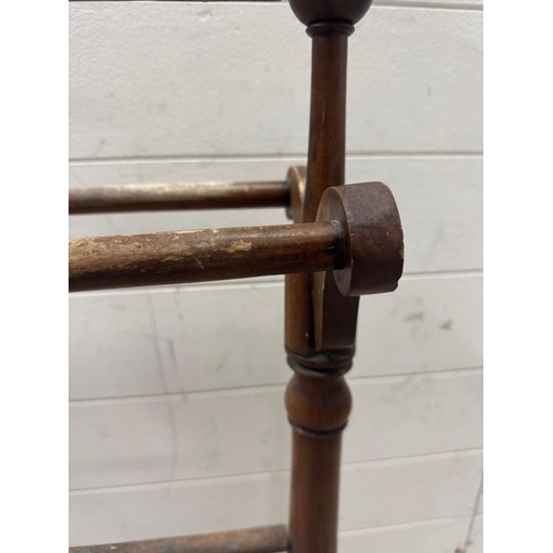 46 - A Mahogany towel rail with turned supports and stretcher on splayed legs