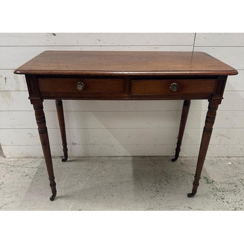 54 - A mahogany two drawer side table on turned legs and castors (H70cm W90cm D46cm)