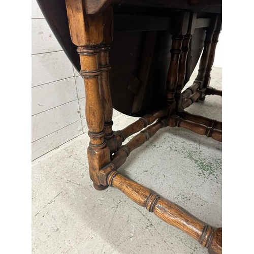 63 - A substantial mahogany gate leg wake table with turned legs and stretchers (H74cm W183cm D150cm)