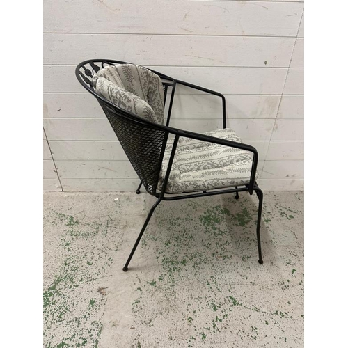 79 - A set of four black metal garden chairs with grey and silver upholstered cushions