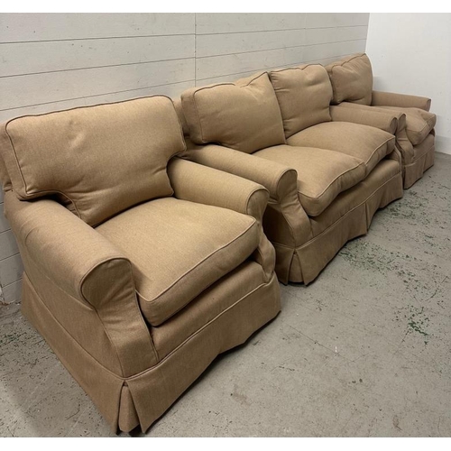 84 - A three seater sofa and two matching arm chairs upholstered in a beige fabric