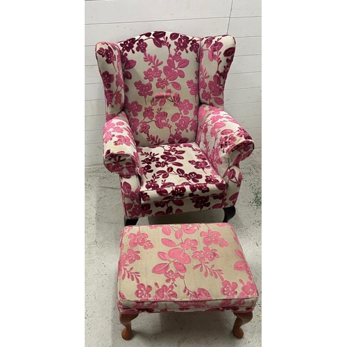 9 - A wing back arm chair upholstered in a floral pattern and an accompanying stool