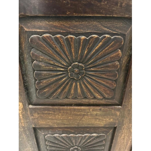 103 - An Indian hardwood cabinet with florally carved panelled doors opening to a single shelf (H77cm W92c... 