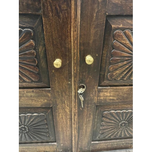 103 - An Indian hardwood cabinet with florally carved panelled doors opening to a single shelf (H77cm W92c... 