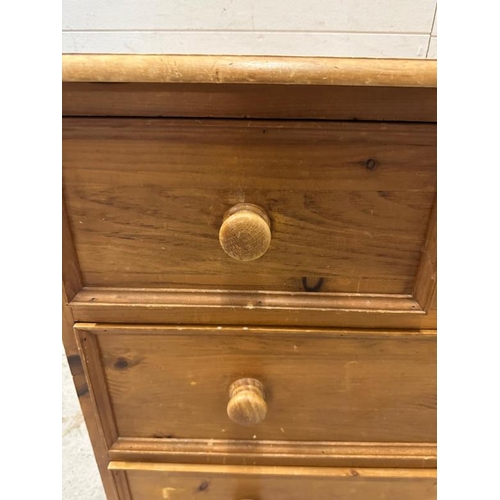 104 - A pine two over two chest of drawers on bun feet (H80cm W85cm D55cm)