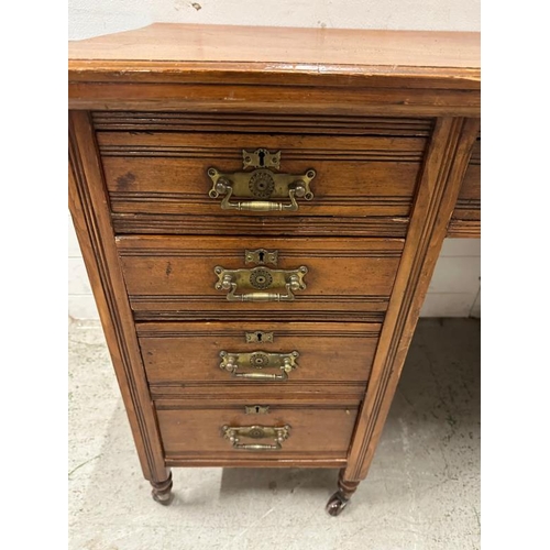 108 - An Edwardian style pedestal desk with one long central drawer flanked by four short drawers