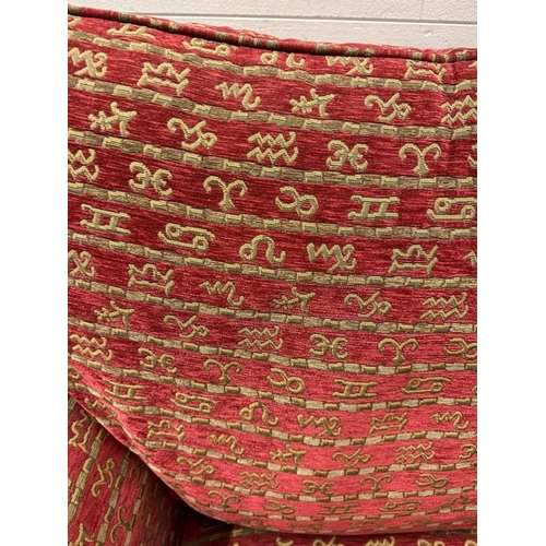 114 - A Duresta single armchair upholstered in a red and gold hieroglyphic pattern