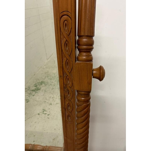 122 - A large pine cheval dressing mirror with turned supports and on splayed triform legs 130cm x 77cm