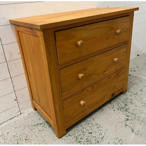 132 - A pine chest of drawers, three long drawers with pull handles (H76cm W84cm D45cm)