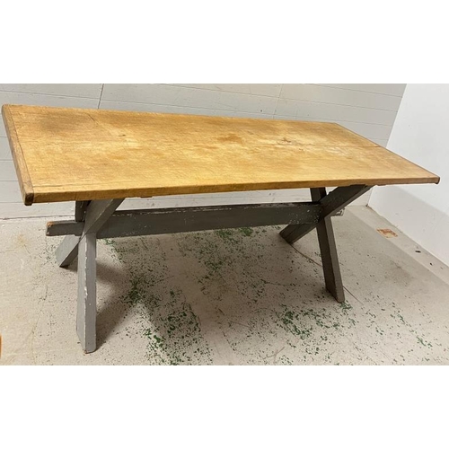 137 - A large pine farmhouse table on X frame legs (H79cm W218cm D82cm)