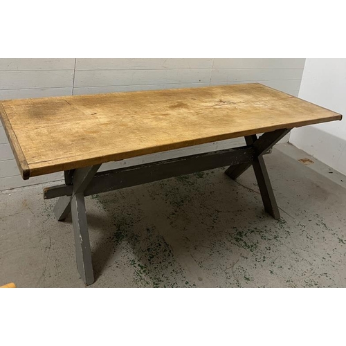 137 - A large pine farmhouse table on X frame legs (H79cm W218cm D82cm)