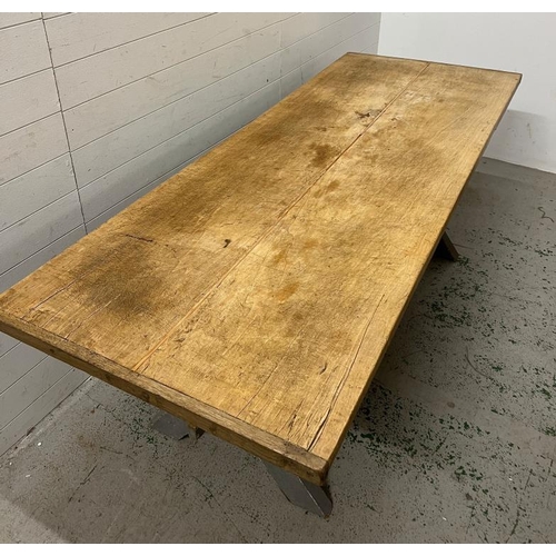 137 - A large pine farmhouse table on X frame legs (H79cm W218cm D82cm)