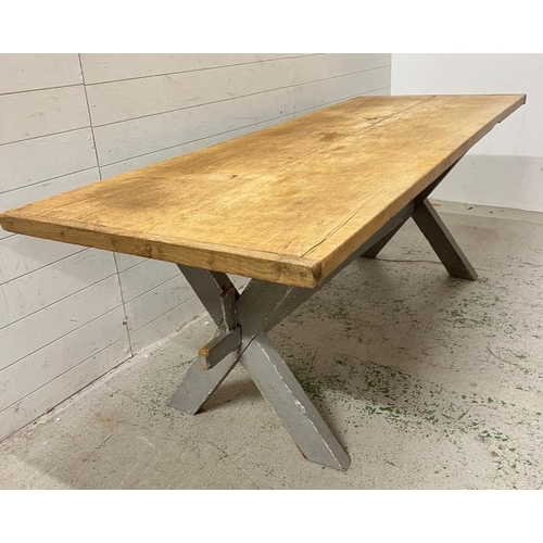 137 - A large pine farmhouse table on X frame legs (H79cm W218cm D82cm)