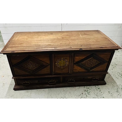 140 - An Indian teak coffer with panelled front and drawers under (H60cm W130cm D60cm)