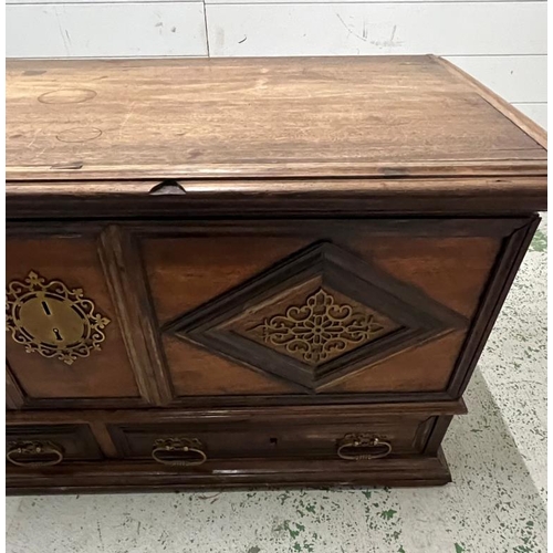 140 - An Indian teak coffer with panelled front and drawers under (H60cm W130cm D60cm)