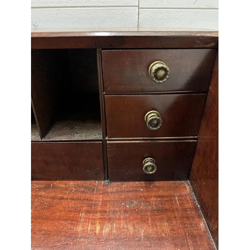 147 - A mahogany four drawer bureau, the fall opening to drawers and storage (H107cm W99cm D48cm)