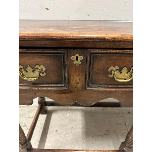 161 - An oak William and Mary style sideboard with two long drawers, brass handles and turned legs. Height... 