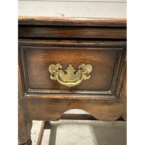 161 - An oak William and Mary style sideboard with two long drawers, brass handles and turned legs. Height... 